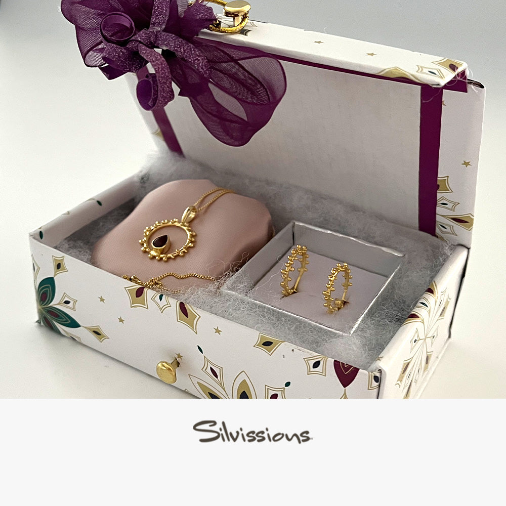 Jewelry set in a decorative box with 'Silvissions' branding.