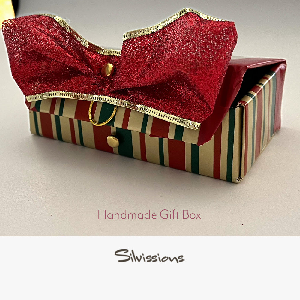 Handmade gift box with a red bow on a light background, branded 'Silvissions'.