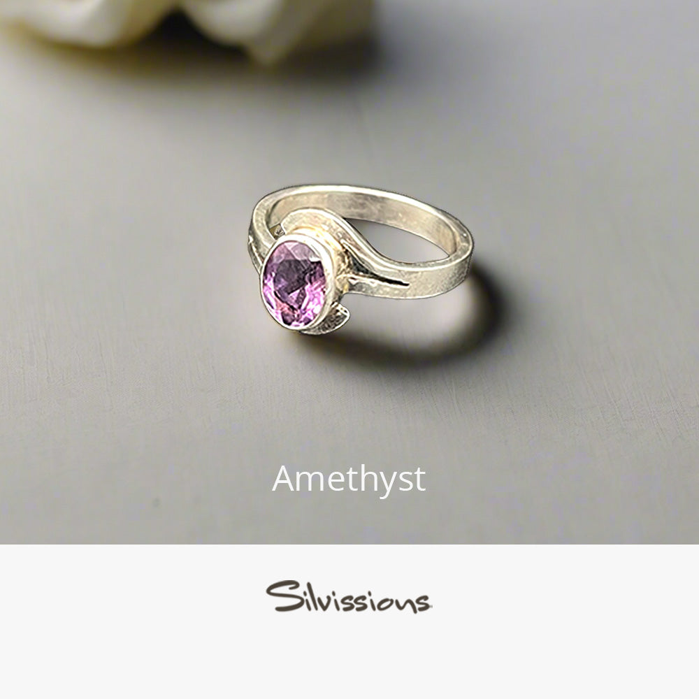Silver ring with a pink amethyst gemstone on a gray background, branded 'Silvissions'.