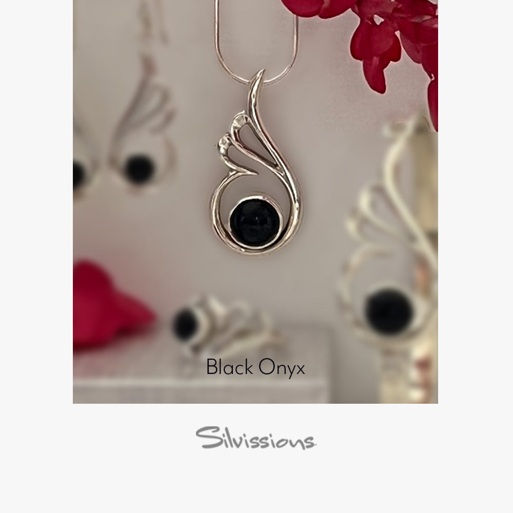Sterling Silver pendant with black onyx stone on a blurred background