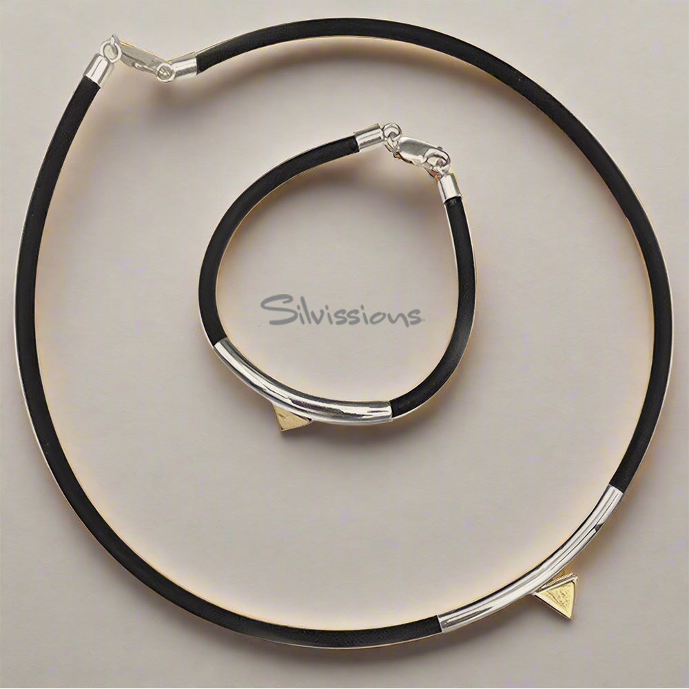 Black necklace with silver and gold accents on a light gray background, featuring the Silvissions brand.