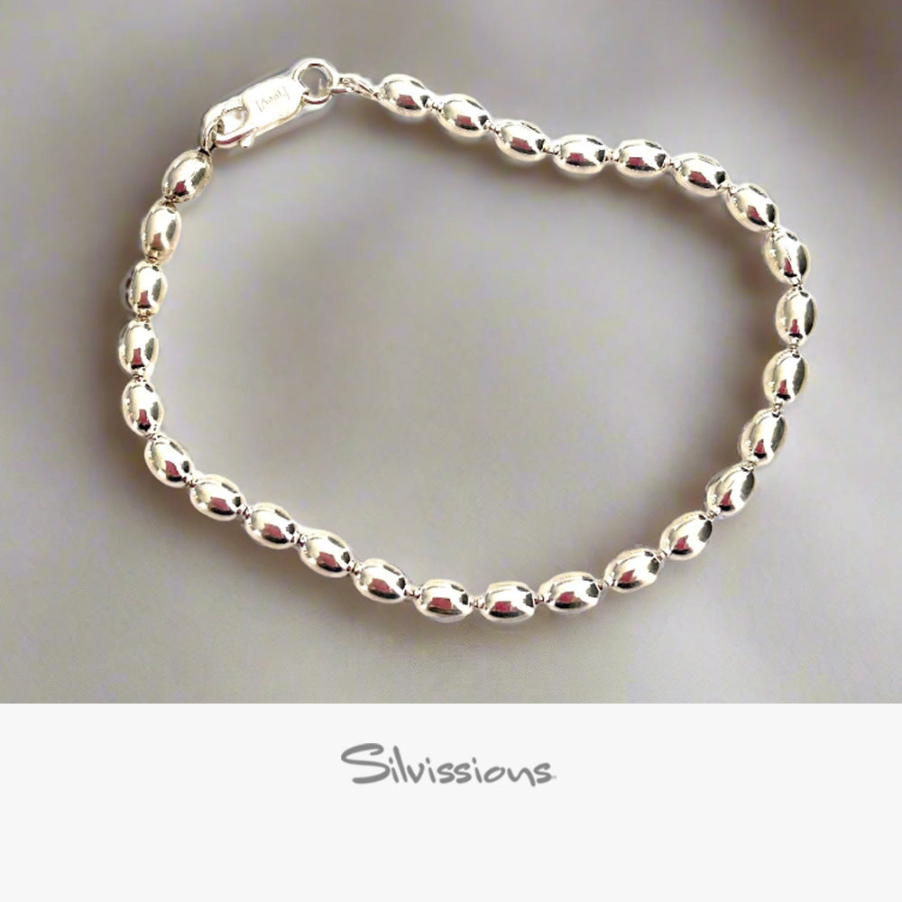 Silver beaded bracelet on a neutral background with 'Silvissions' branding.