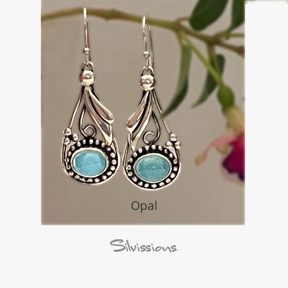 Pair of silver earrings with blue stones on a beige card, featuring the brand 'Silvissions'.