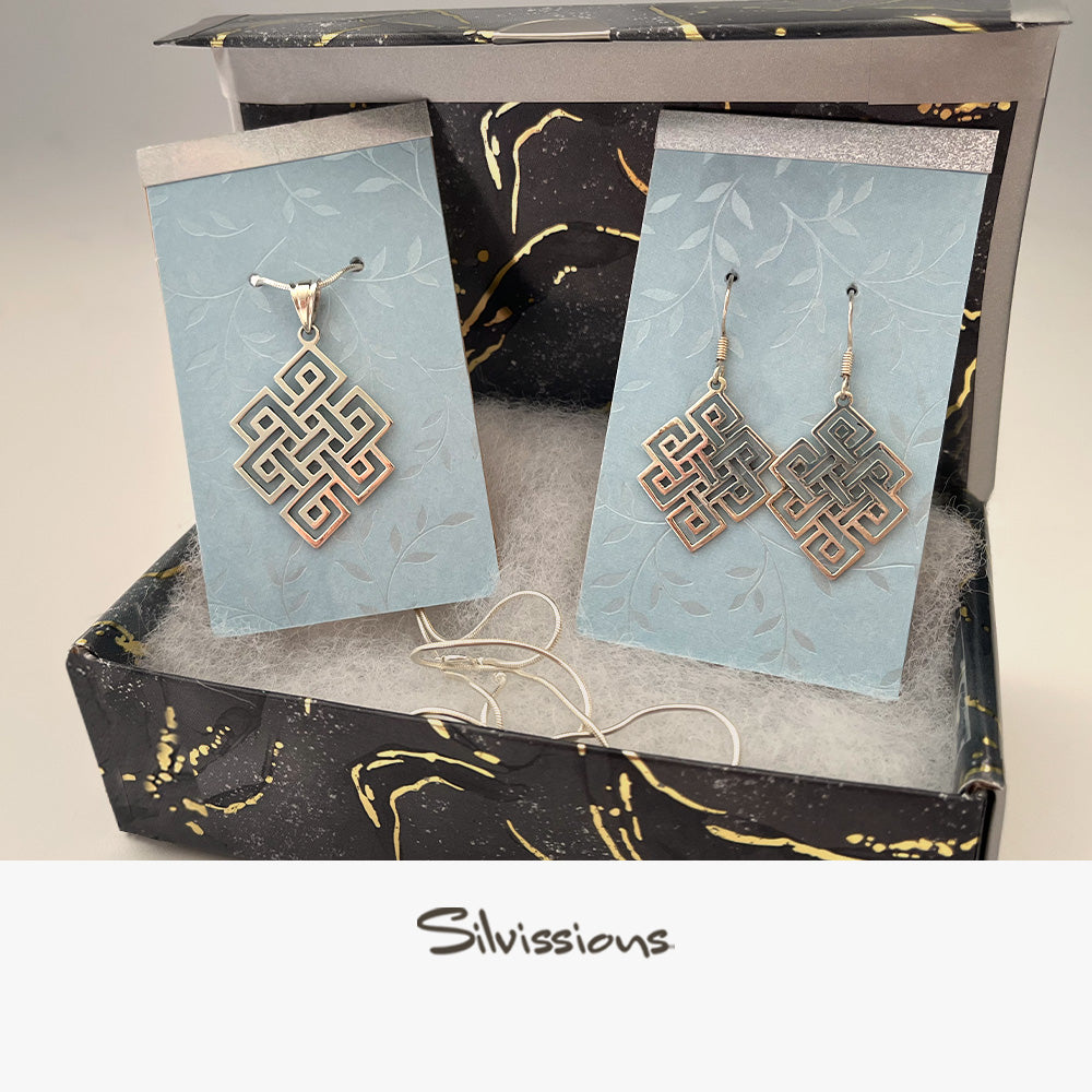 Jewelry set with earrings and a necklace on cards, branded 'Silvissions'.