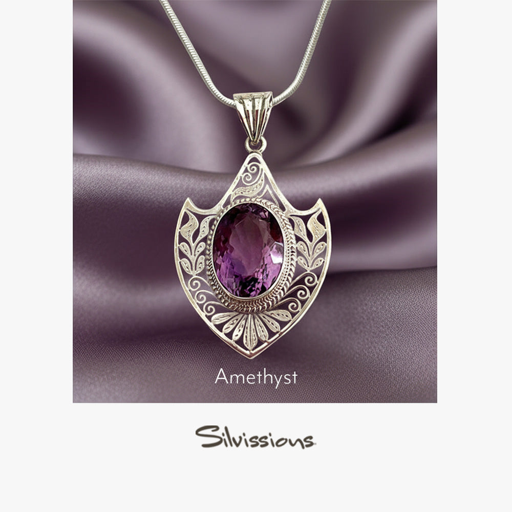 Silver pendant with purple gemstone on a purple fabric background, featuring the brand 'Silvissions'.