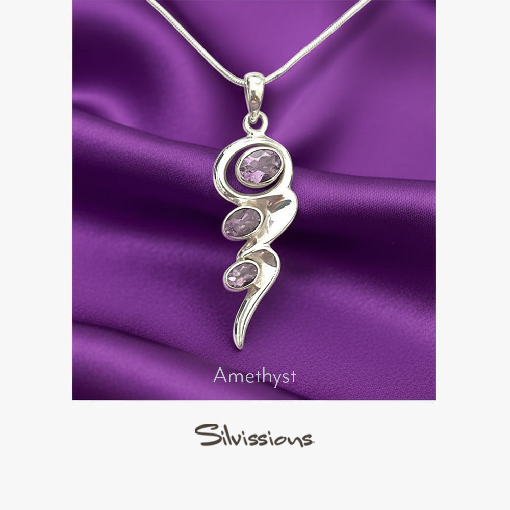 Silver pendant with amethyst stones on a purple satin background, featuring the brand 'Silvissions'.