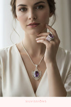 A woman wearing a silver pendant necklace with a purple amethyst stone and a matching silver ring with a purple stone. The brand name 'SILVISSIONS' is printed at the bottom of the image.