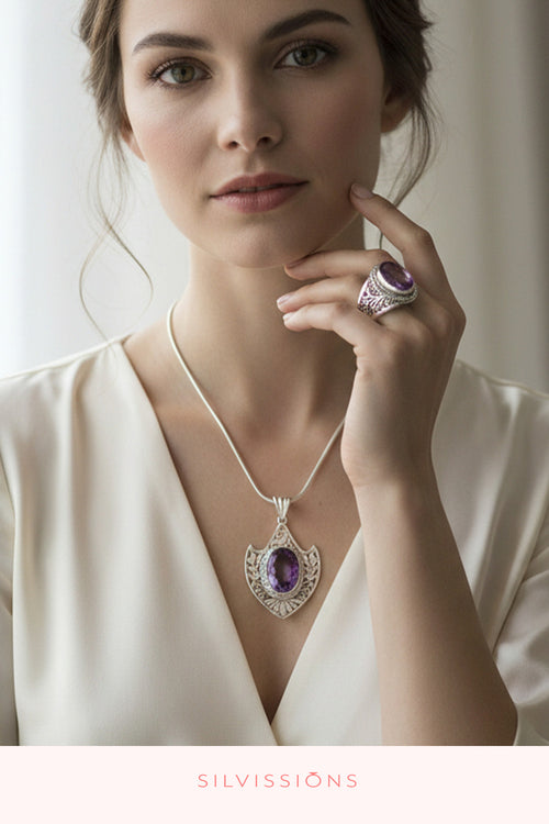 A woman wearing a silver pendant necklace with a purple amethyst stone and a matching silver ring with a purple stone. The brand name 'SILVISSIONS' is printed at the bottom of the image.