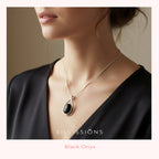 Necklace with a black pendant worn by a person, brand 'Silvissions' visible