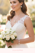 Woman wearing jewelry with a blurred floral background, featuring the brand 'Silvission'.
