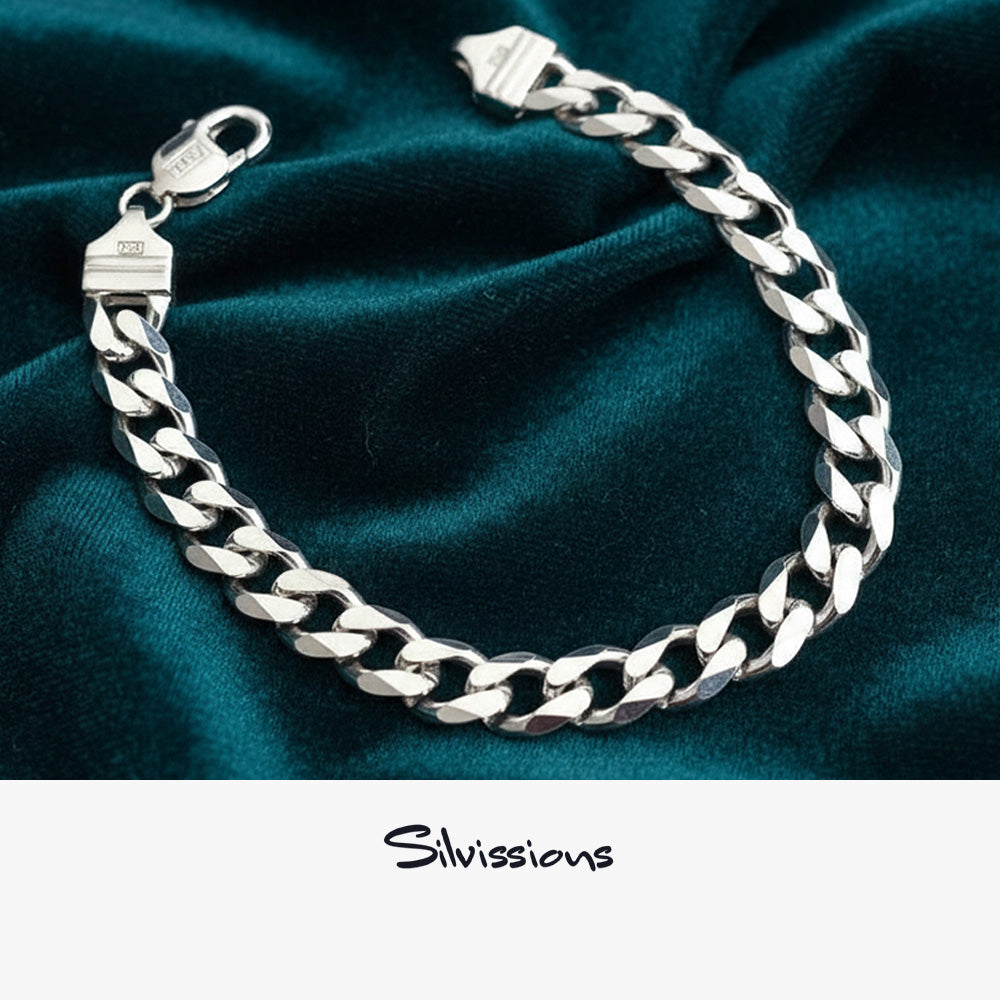 Cubn chain bracelet in sterling silver on a dark teal fabric background with 'Silvissions' branding.