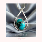 Silver pendant with turquoise stone on a silver fabric background, featuring the brand 'Silvissions'.