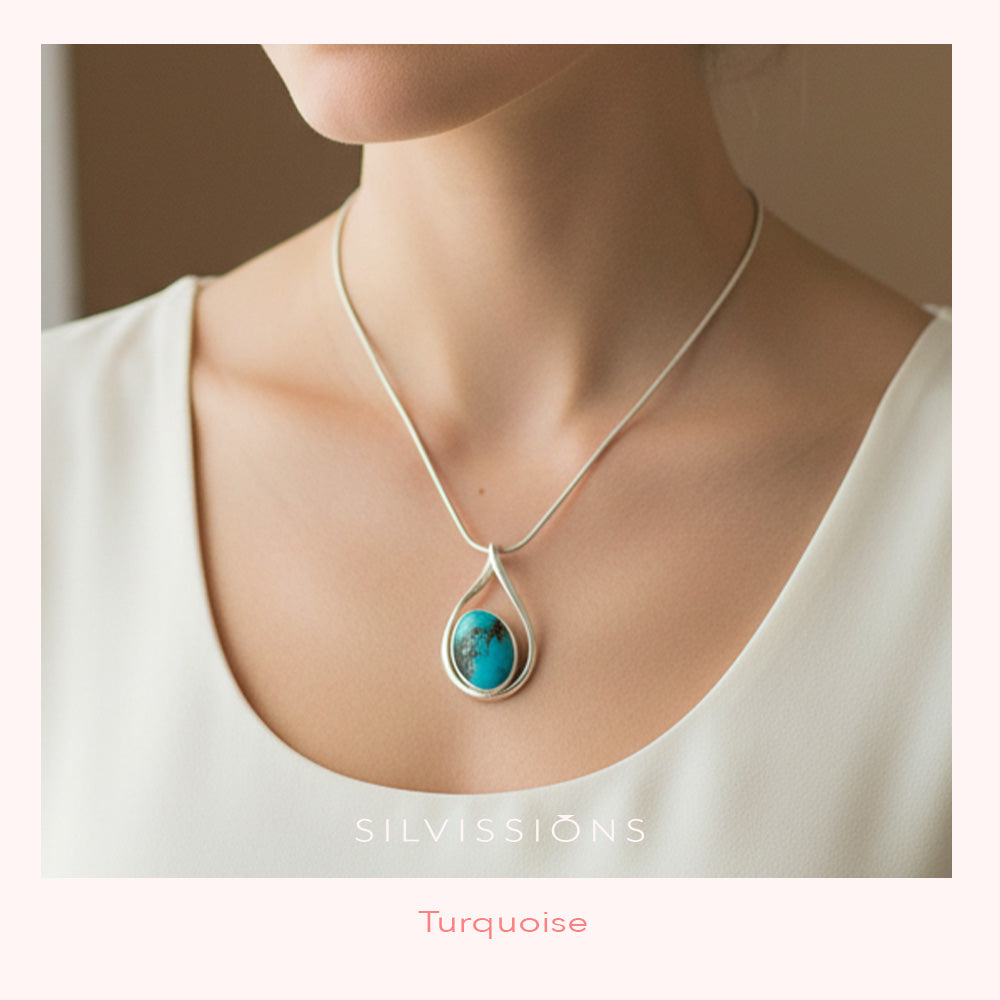 Necklace with a turquoise pendant worn by a person, brand 'Silvissions' visible