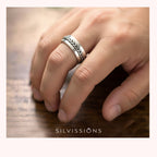 Silver ring with foxtail weave design on a finger, brand 'Silvissions' visible