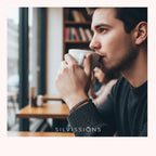 Man drinking from a coffee cup in a cafe setting with 'Silviissions' branding.