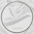 Silver necklace on a satin background with 'Silvissions' branding.