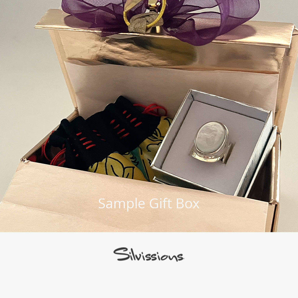 Open box containing a mother of pearl gemstone ring with a handmade pouch, with 'Silvissions' branding.