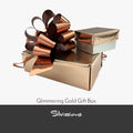 Glimmering gold gift box with a decorative bow on a white background, featuring the brand 'Silvissions'.