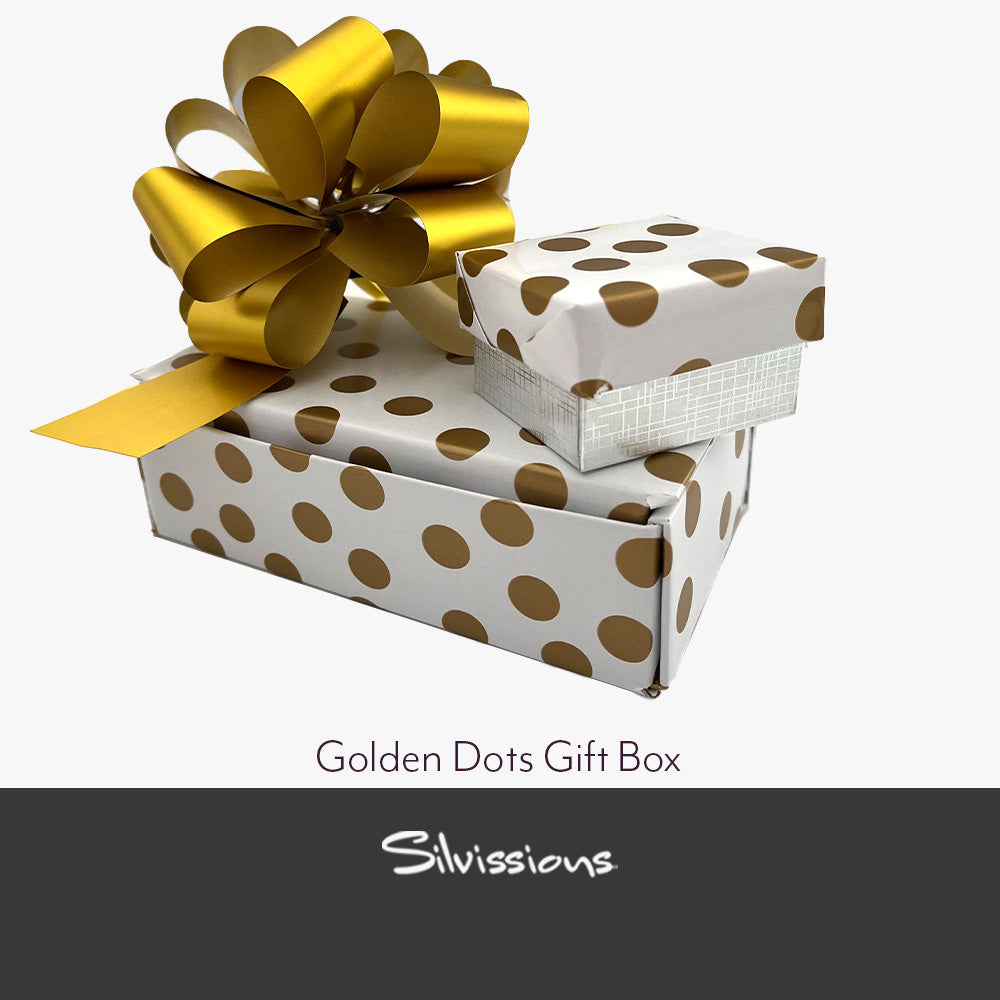 Handmade gift box with gold accents and a gold ribbon on a beige background, branded 'Silviussions'.
