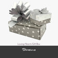 Gray gift box with white heart patterns and a matching bow, branded 'Silvissions'.