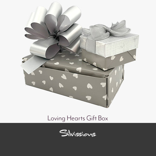 Gray gift box with white heart patterns and a matching bow, branded 'Silvissions'.