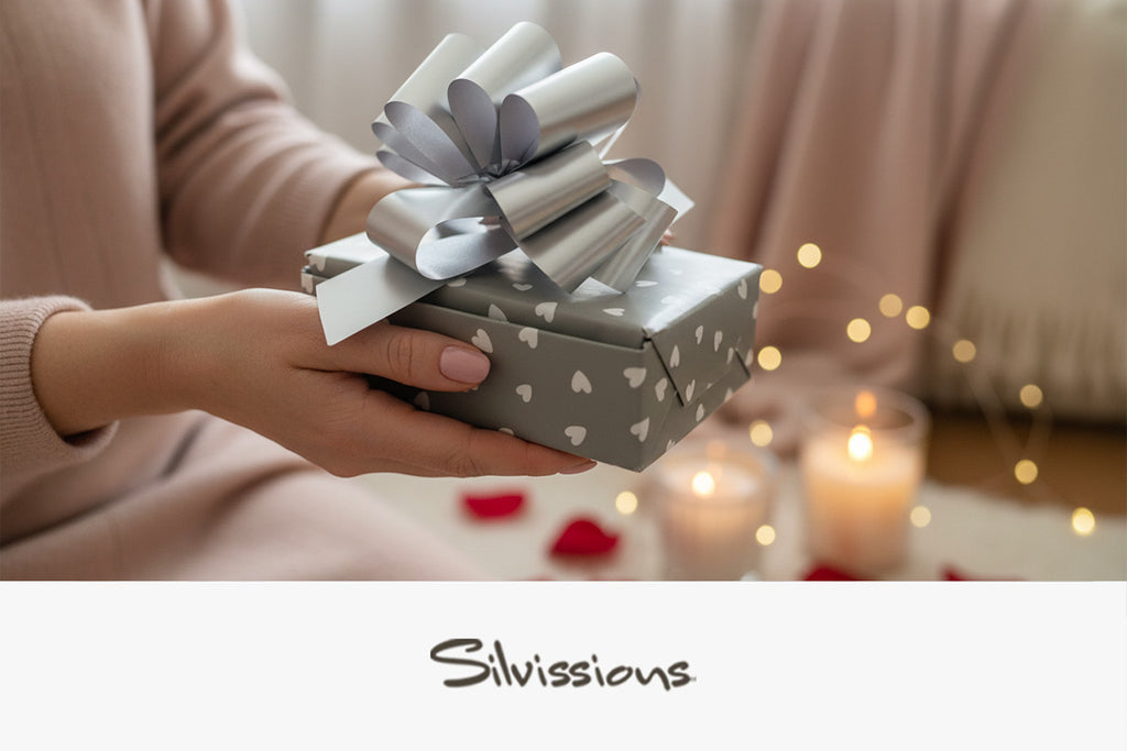 Person holding a gift box with a large bow, blurred lights in the background, and 'Silviissions' branding.