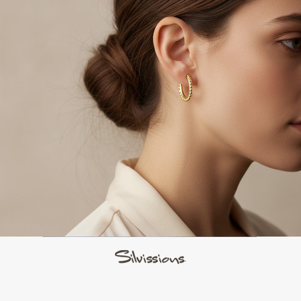 Gold plated hoop stud earring worn by a model with a neutral background, featuring the brand 'Silvivisions'.