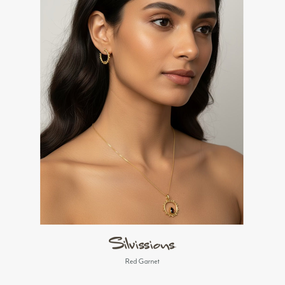 Woman wearing gold jewelry with 'Silvissions' branding on a neutral background