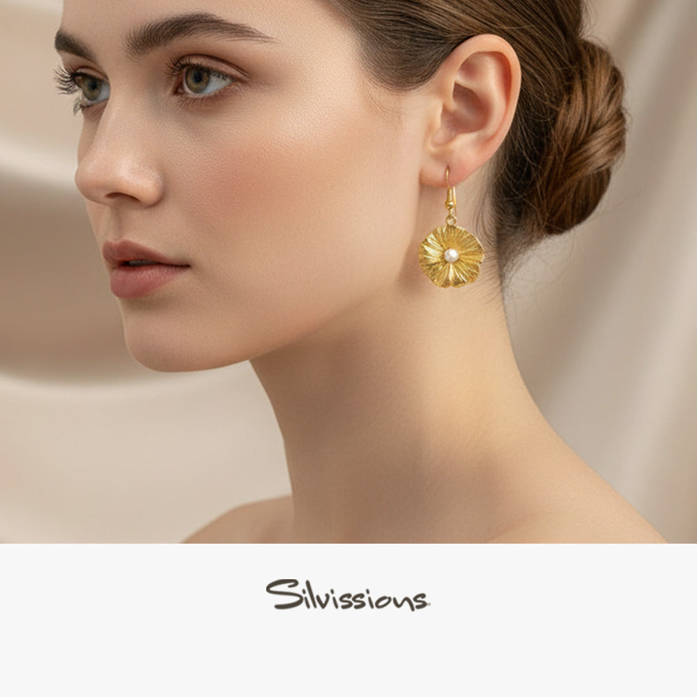 Gold plated pearl earring worn by a model with 'Silvissions' branding.