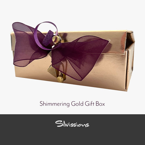 Shimmering gold gift box with a purple bow and 'Silvissions' branding.