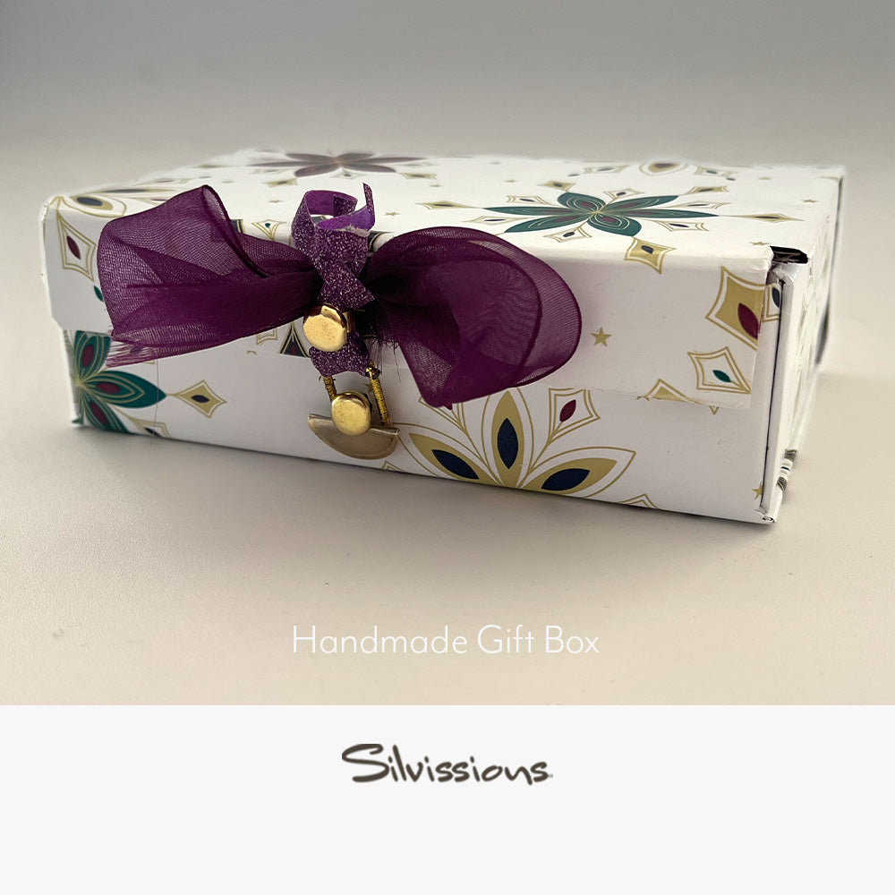 Handmade gift box with floral pattern and purple bow on a white background, branded 'Silvissions'.