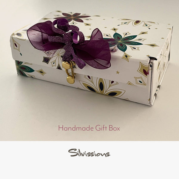 Handmade gift box with floral pattern and purple bow on a white background, branded 'Silvissions'.