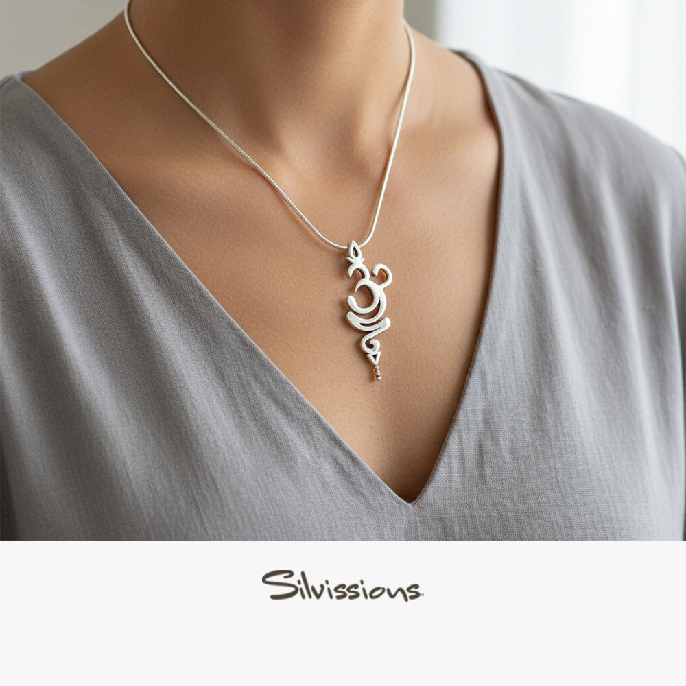 Silver necklace with a pendant on a person wearing a gray top, branded 'Silvissions'.