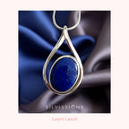 Silver pendant with blue stone necklace on a dark fabric background, featuring the brand 'Silviissions'.