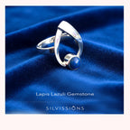 Silver ring with lapis lazuli stone on blue fabric, featuring 'Silvissions' brand.