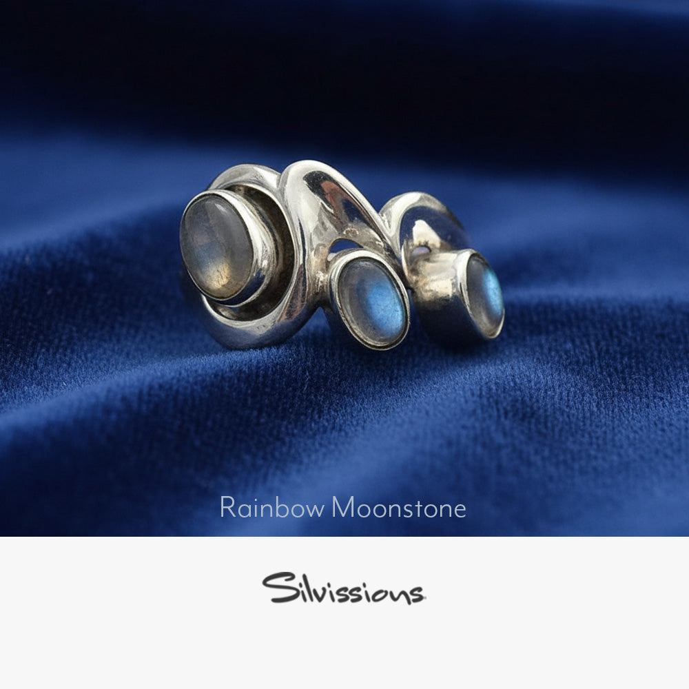 Silver ring with rainbow moonstone stones on a neutral background