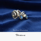 Silver ring with rainbow moonstone stones on a neutral background