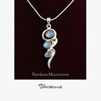 Silver pendant with rainbow moonstone stones on a dark background, branded 'Silvissions'.
