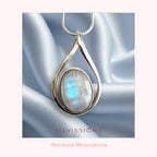 Silver pendant with rainbow moonstone on a white satin background, featuring the brand 'Silvissions'.