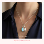 Necklace with a moonstone pendant on a woman wearing a dark shirt, branded 'Silvissions'.