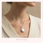 Necklace with a mother of pearl stone pendant worn by a person, brand 'Silvissions' visible