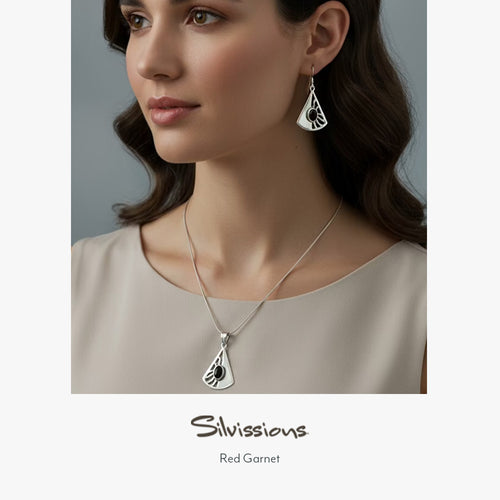 Woman wearing silver necklace and earrings with 'Silvissions' branding.