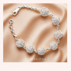 Silver ball bracelet with spherical designs on a beige fabric background, featuring the brand 'Silvissions'.