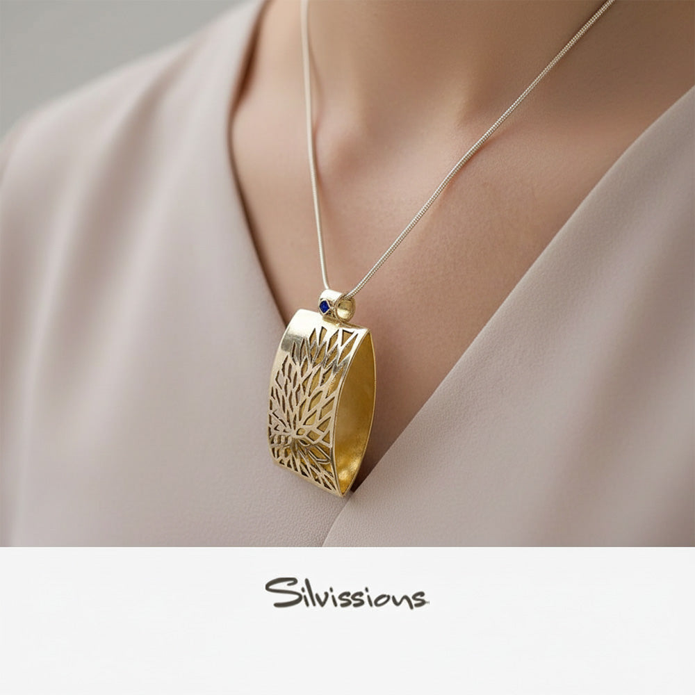 Silver and Gold pendant necklace on a model with 'Silvissions' branding.
