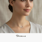 Silver necklace with interlocking rings worn by a person, brand 'Silvissions' visible