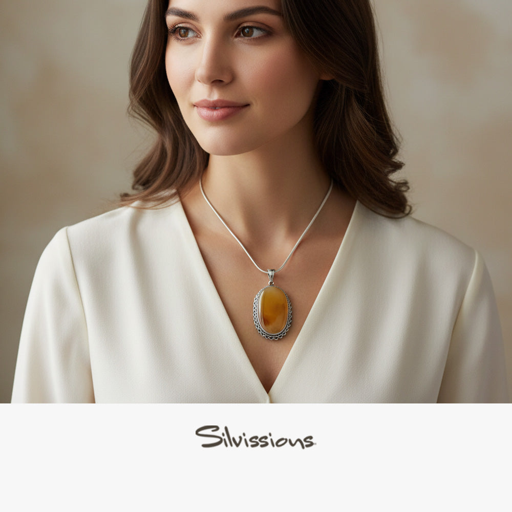 Woman wearing a necklace with a brown gemstone pendant, branded 'Silvissions'.