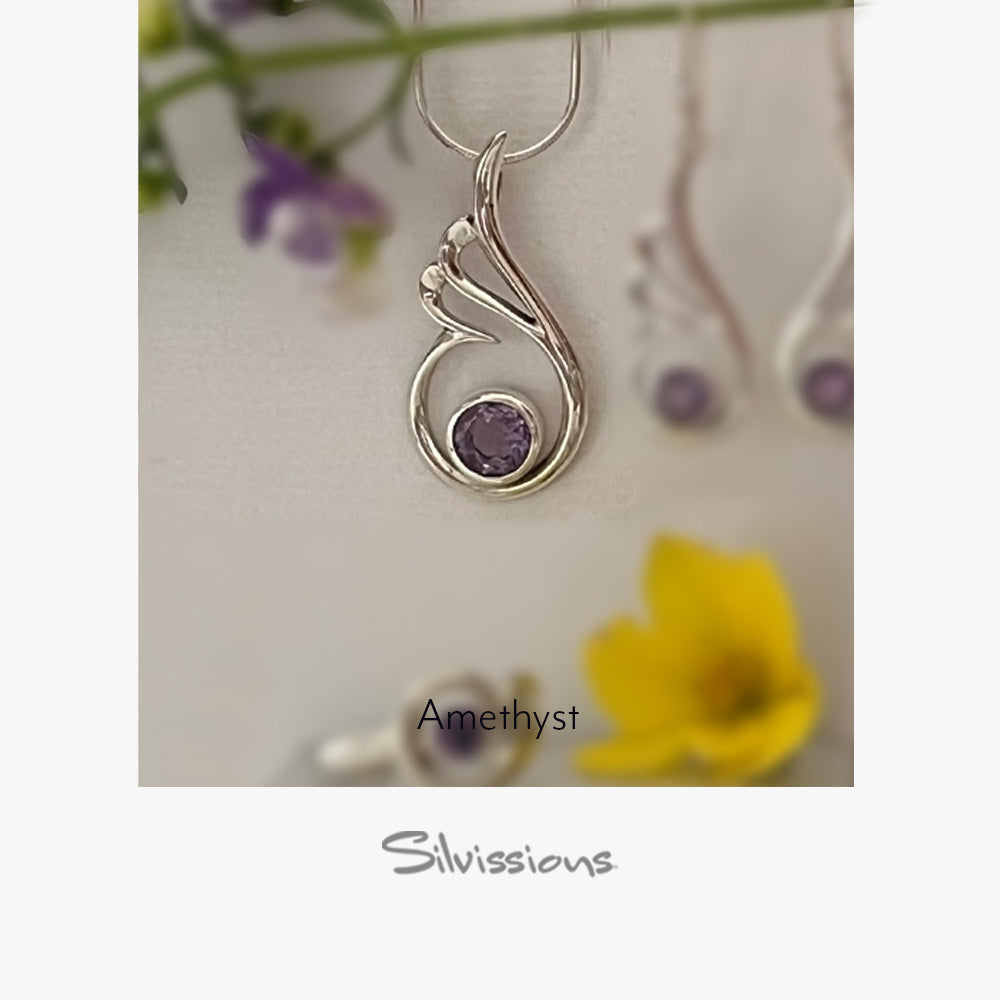 Silver pendant with purple gemstone on a card with flowers in the background, featuring the brand 'Silvissions'.