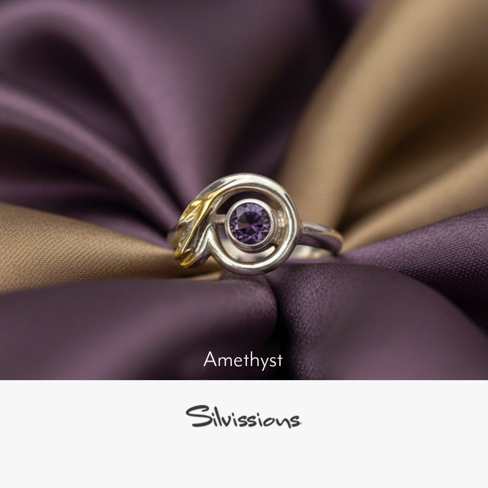 Silver ring with a purple gemstone on a neutral background, featuring the brand 'Silvissions'.