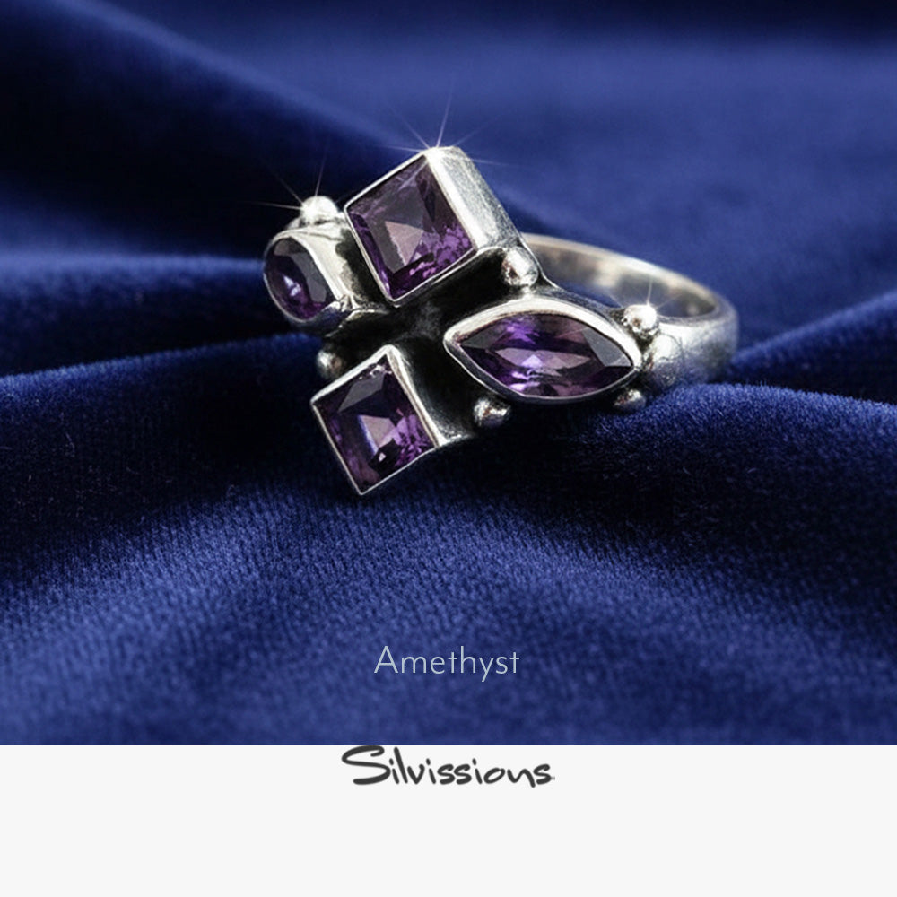 Silver ring with purple amethyst stones on a gray surface, featuring the brand 'Silvissions'.