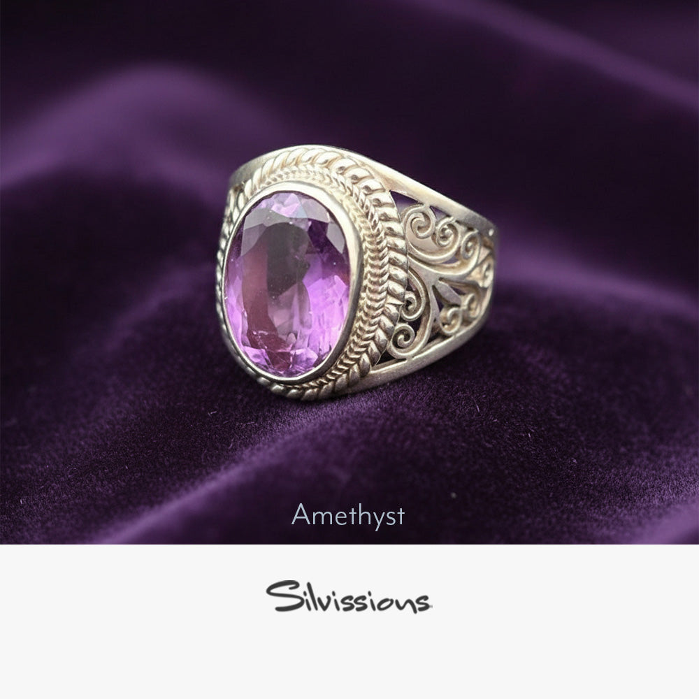 Silver ring with a pink amethyst stone on purple fabric, branded 'Silvissions'.